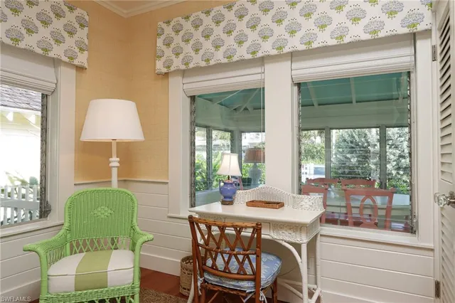 a dining room with furniture and a window