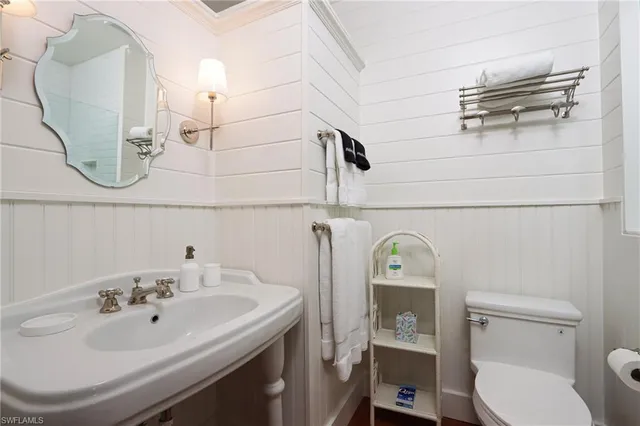 a bathroom with a sink a toilet and mirror