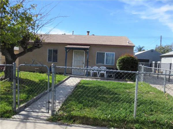 a front view of house with yard and outdoor seating