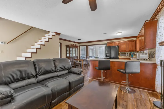 a living room with furniture and a kitchen view