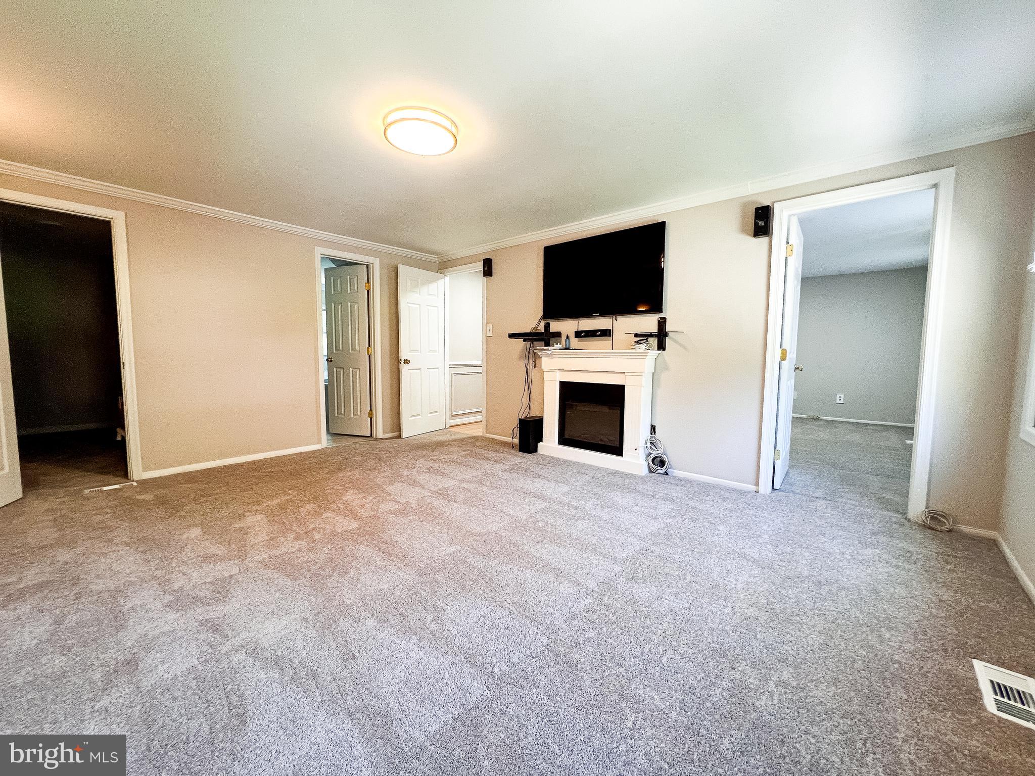 14913 Lear Lane Silver Spring, MD 20905 - Photo 15 of 34 a view of a livingroom with a flat screen tv and fireplace