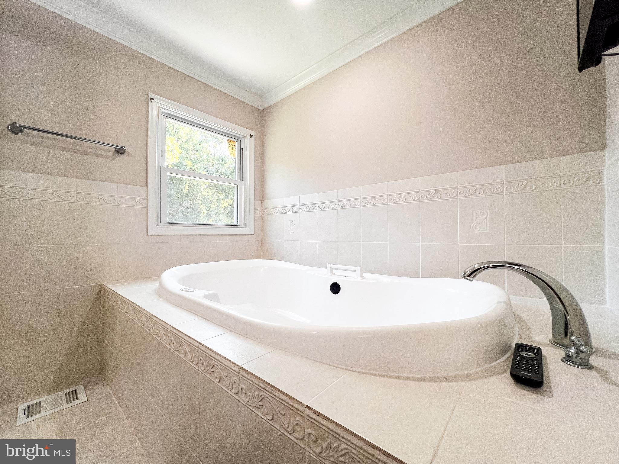 14913 Lear Lane Silver Spring, MD 20905 - Photo 18 of 34 a white bath tub sitting in a bathroom