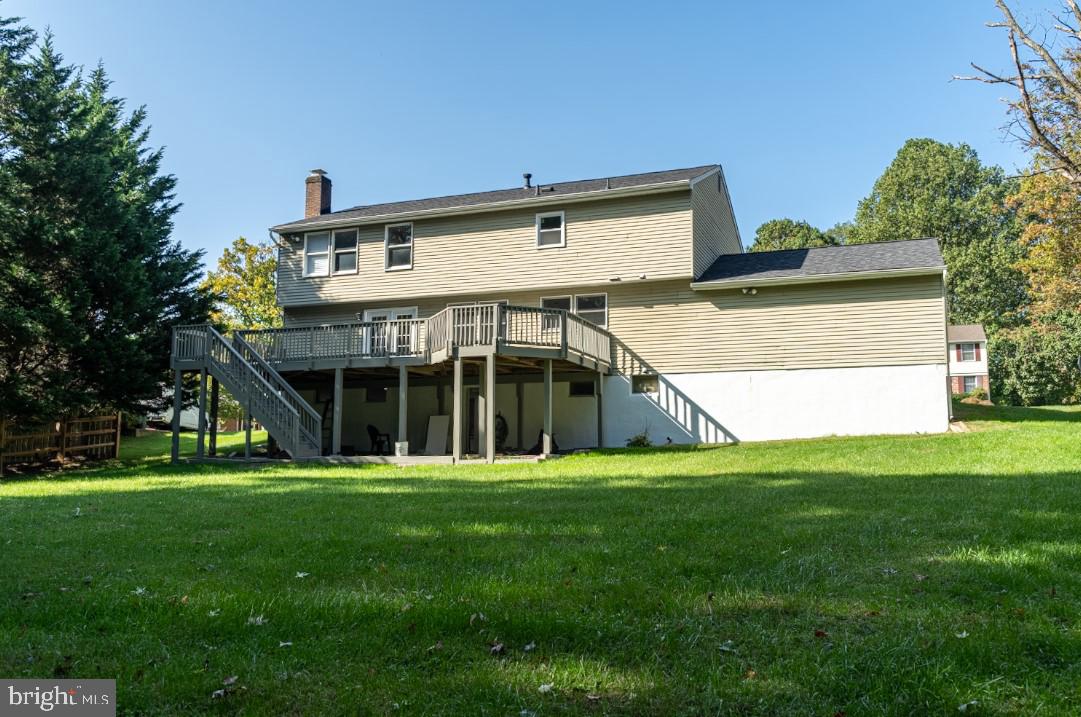 14913 Lear Lane Silver Spring, MD 20905 - Photo 34 of 34 a view of a white house with a big yard and large trees