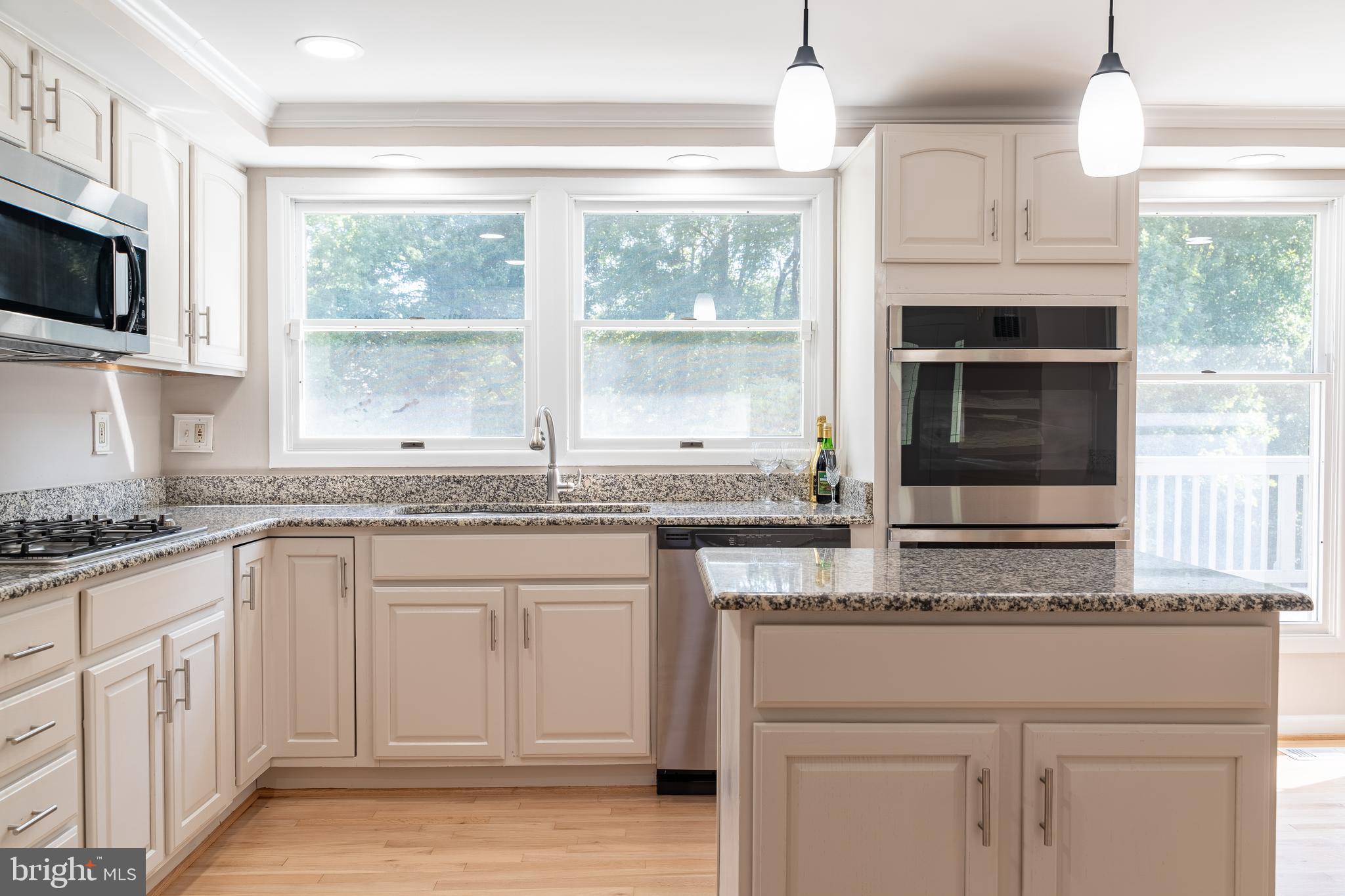14913 Lear Lane Silver Spring, MD 20905 - Photo 5 of 34 a kitchen with granite countertop white cabinets and a window
