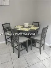 a view of a dining room with furniture and a table