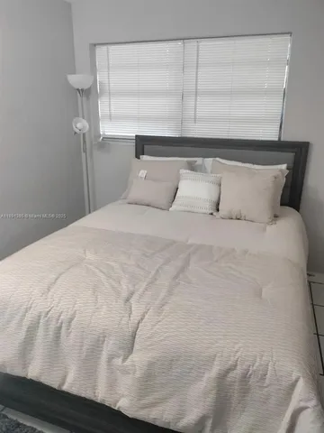 a large white bed in a white room