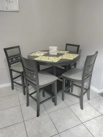 a view of a dining room that has a table and chairs in it