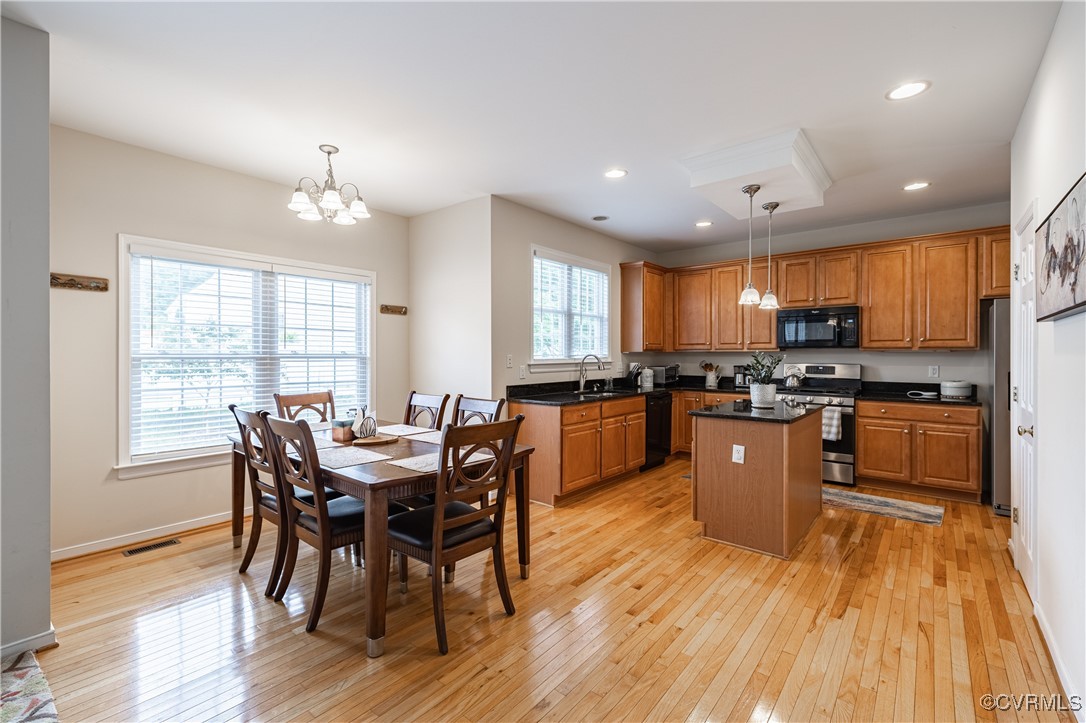 9500 Meadowview Road Henrico, VA 23294 - Photo 17 of 49 a view of a dining room with furniture windows and wooden floor