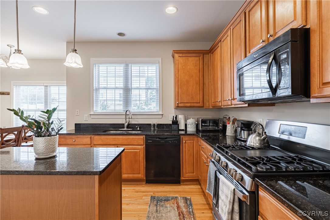 9500 Meadowview Road Henrico, VA 23294 - Photo 19 of 49 a kitchen with stainless steel appliances granite countertop a sink a stove and a wooden floors