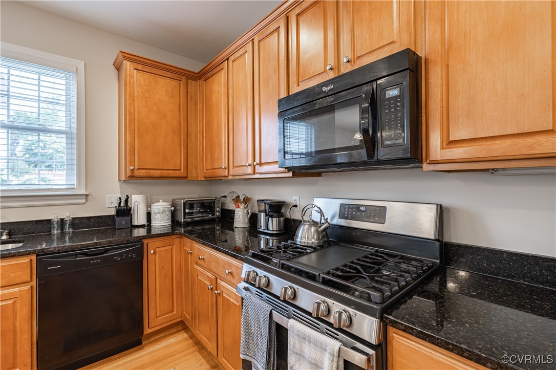 9500 Meadowview Road Henrico, VA 23294 - Photo 20 of 49 a kitchen with stainless steel appliances granite countertop a stove a sink dishwasher and cabinets with wooden floor