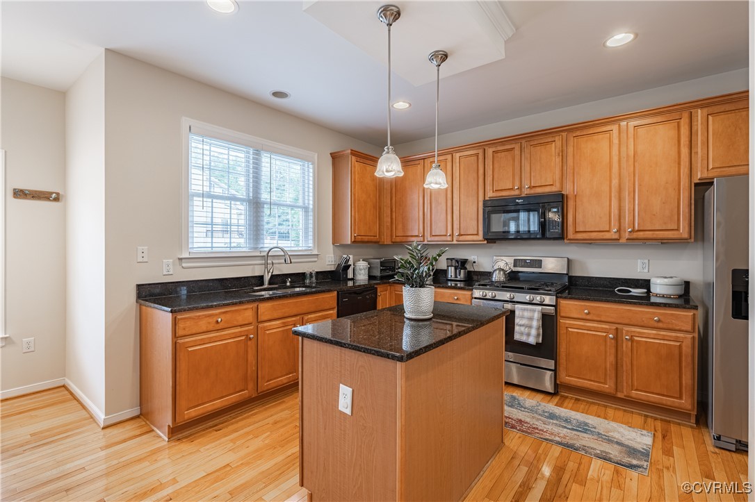 9500 Meadowview Road Henrico, VA 23294 - Photo 23 of 49 a kitchen with stainless steel appliances granite countertop a stove a sink dishwasher a refrigerator and a microwave oven with wooden floor