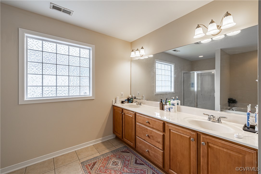 9500 Meadowview Road Henrico, VA 23294 - Photo 35 of 49 a bathroom with double vanity and a mirror