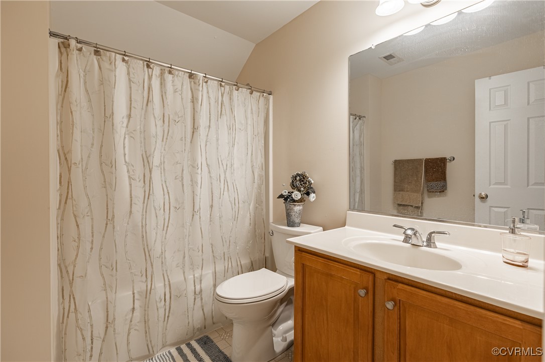 9500 Meadowview Road Henrico, VA 23294 - Photo 47 of 49 a bathroom with a sink a toilet and shower curtain