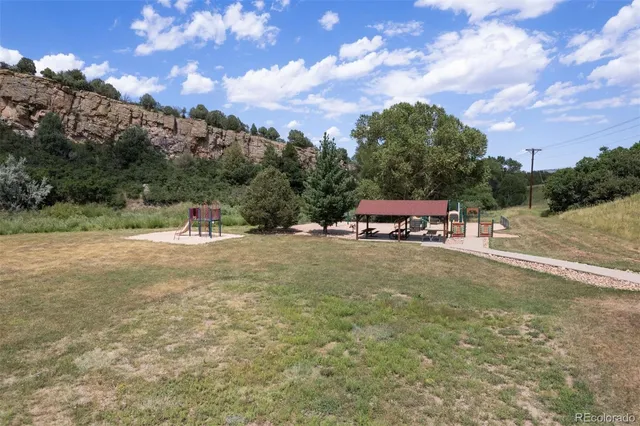 a view of outdoor space with playground and green space