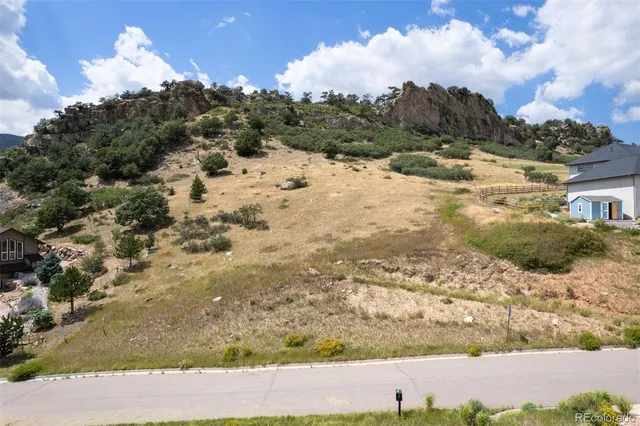 a view of a yard with wooden fence