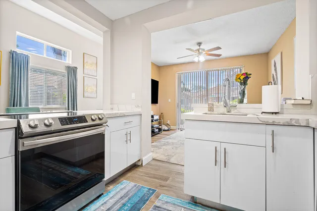 a kitchen with stainless steel appliances granite countertop a stove and a sink
