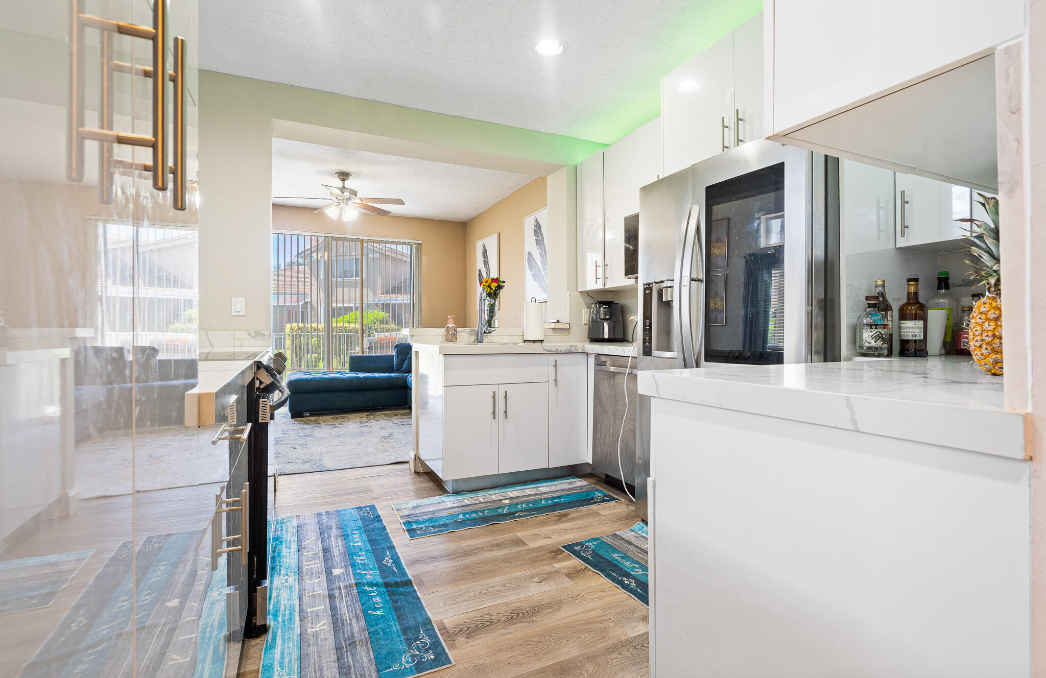 15822 Southwest 10th Street Pembroke Pines, FL 33027 - Photo 13 of 37 a kitchen with stainless steel appliances kitchen island granite countertop a refrigerator and a stove