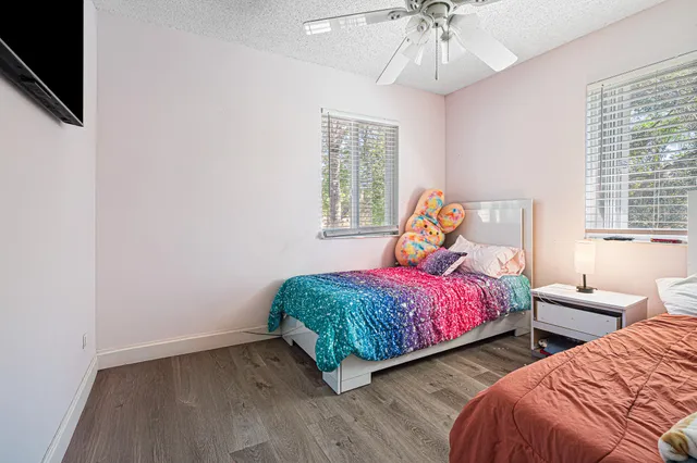 a bedroom with two beds and a chandelier