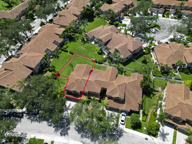 an aerial view of multiple houses with yard
