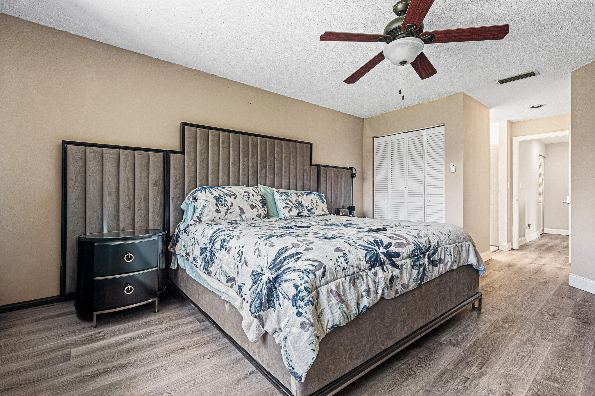 15822 Southwest 10th Street Pembroke Pines, FL 33027 - Photo 26 of 37 a bedroom with a bed and a chandelier