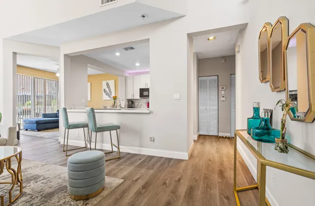 a living room with furniture and wooden floor