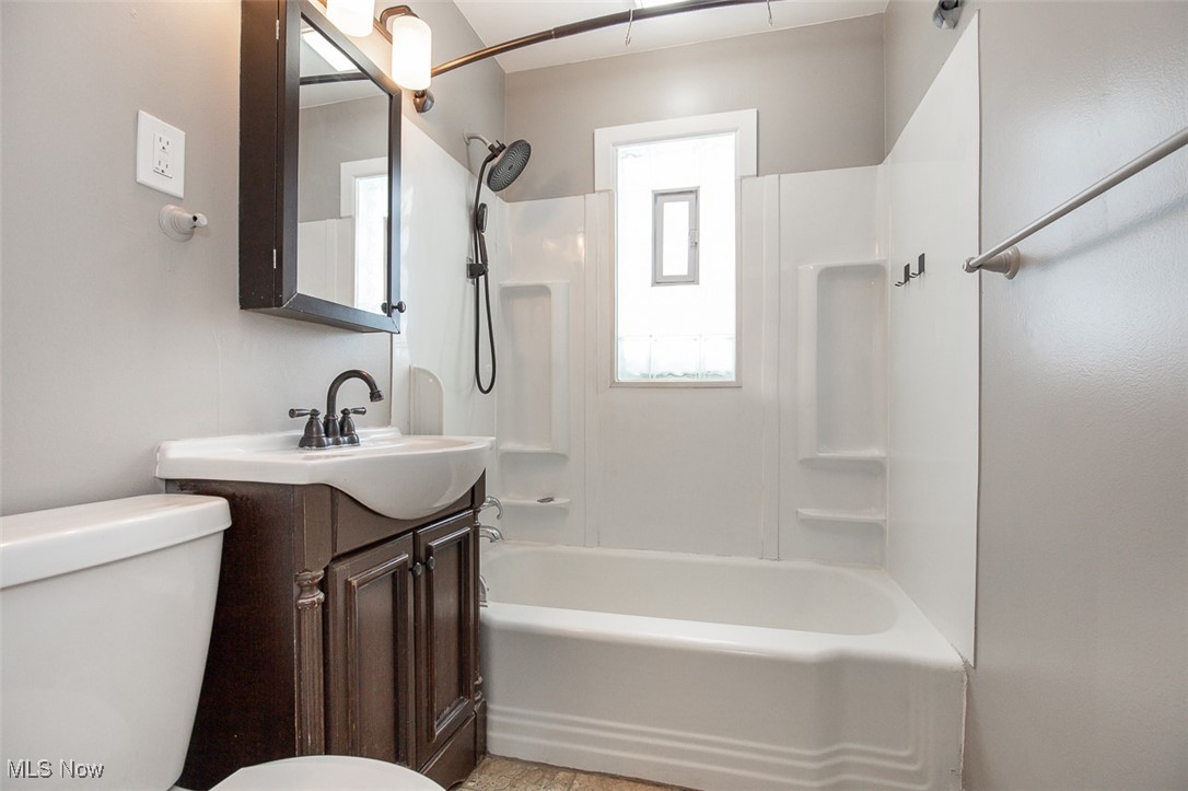 12328 Granger Road Cleveland, OH 44125 - Photo 16 of 37 Full bathroom featuring vanity and shower combination