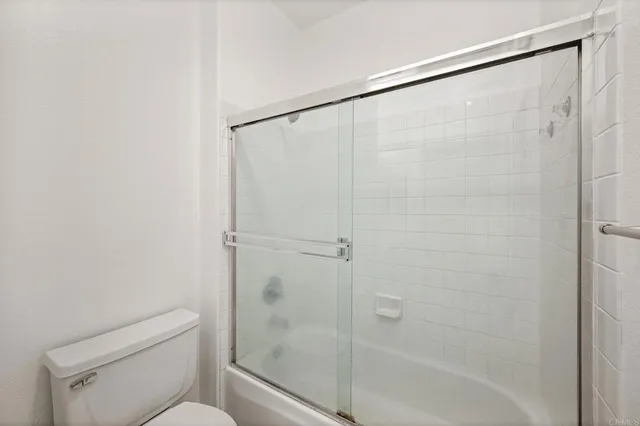 a bathroom with a shower and a toilet