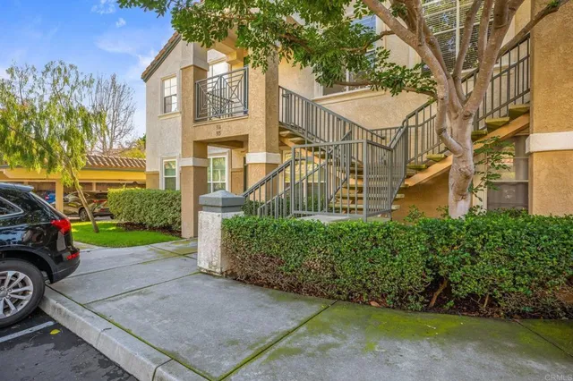 a view of a street with a house in the background