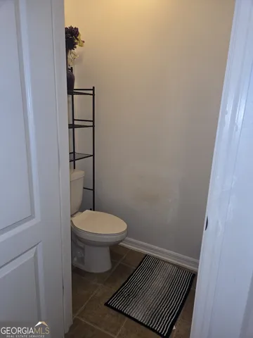 a living room with stainless steel appliances kitchen island granite countertop furniture and a rug