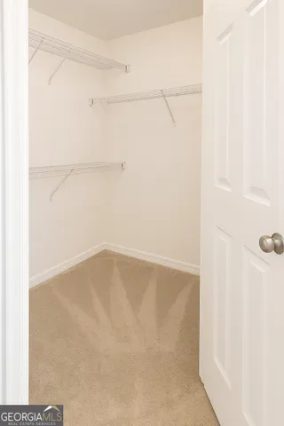 a view of a livingroom with an empty space and a window