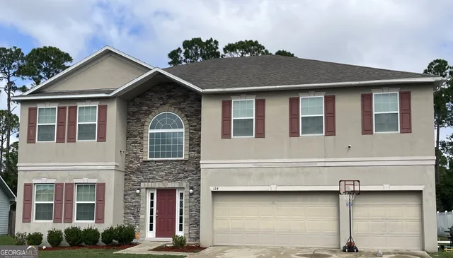 a front view of a house with garage