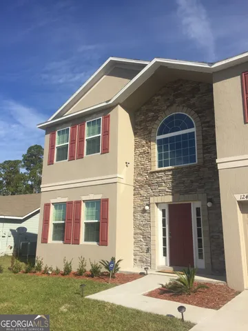a front view of a house with a yard