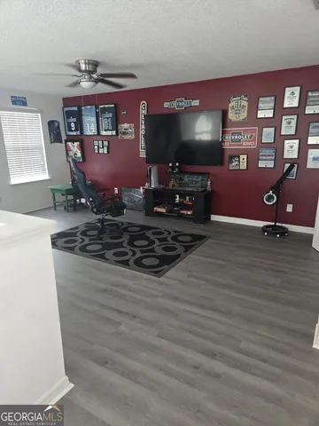 a kitchen with stainless steel appliances kitchen island granite countertop a sink a stove a microwave and a dining table