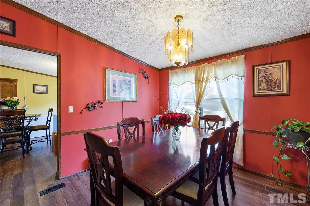 6604 Stokes Road Middlesex, NC 27557 - Photo 8 of 15 a view of a dining room with furniture window and wooden floor
