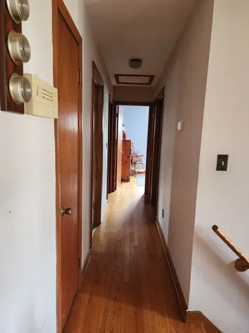 a view of a hallway with wooden floor