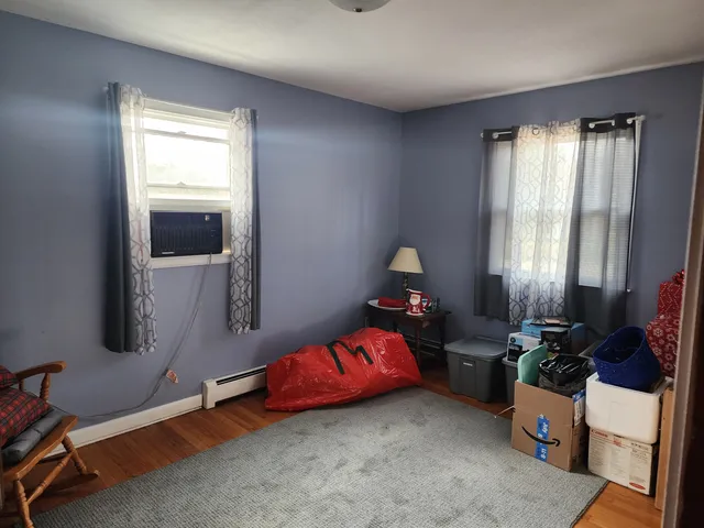 a bedroom with bed and window