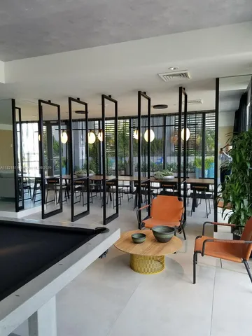 a living room with furniture window and a potted plant