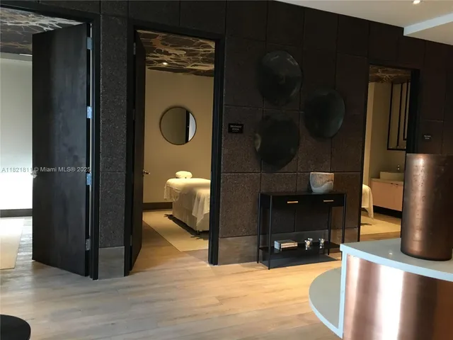 a dining room with furniture and large windows