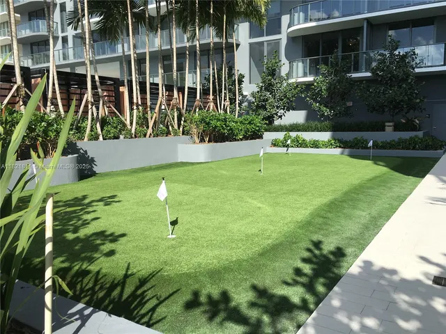 a living room with furniture a flat screen tv and a window