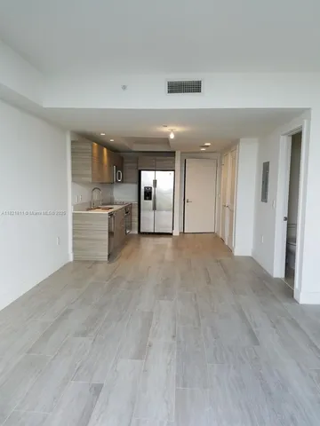 a kitchen with stainless steel appliances granite countertop a sink and a microwave