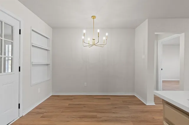 a view of a room with wooden floor and staircase