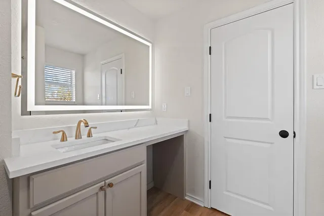 a bathroom with a sink and a mirror