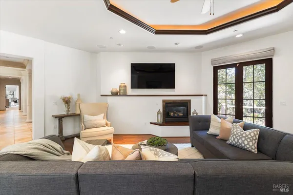 a living room with furniture a flat screen tv and a fireplace
