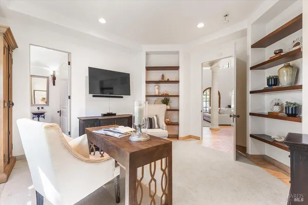 a dining room with furniture and a flat screen tv