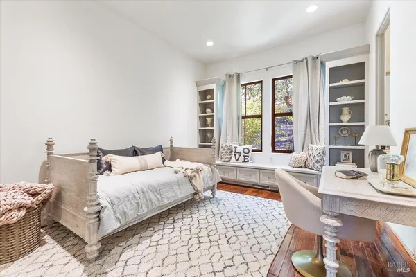 a bedroom with a bed and window with couch