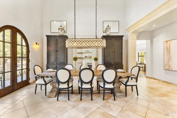 a view of a dining room with furniture and a large window