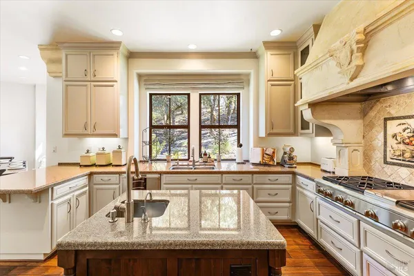 a kitchen with granite countertop stainless steel appliances window a sink and cabinets