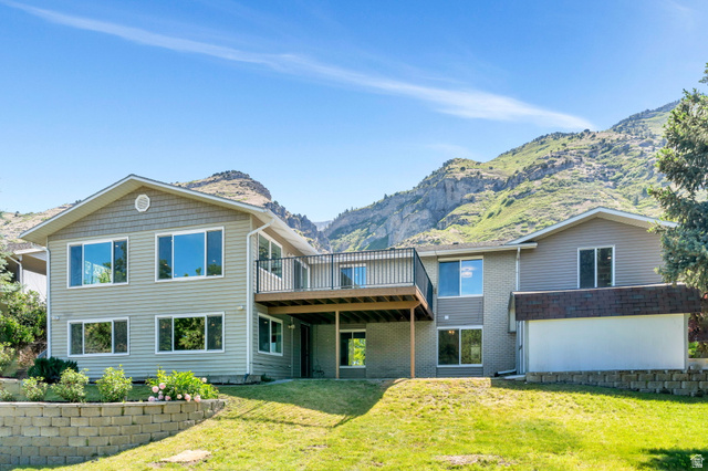 3813 North Foothill Drive Provo, UT 84604 - Photo 51 of 71 Two-story residence featuring light gray siding, a second-story balcony with dark railings, and multiple large windows