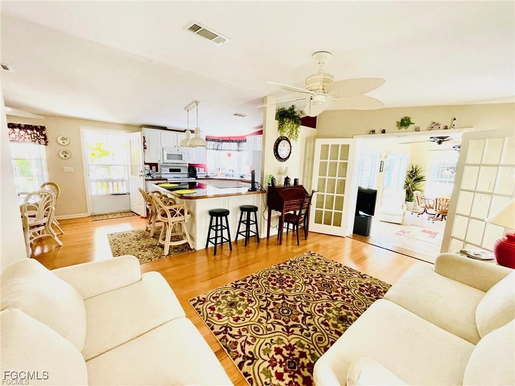 3064 Sloop Lane St. James City, FL 33956 - Photo 15 of 30 a living room with furniture and wooden floor