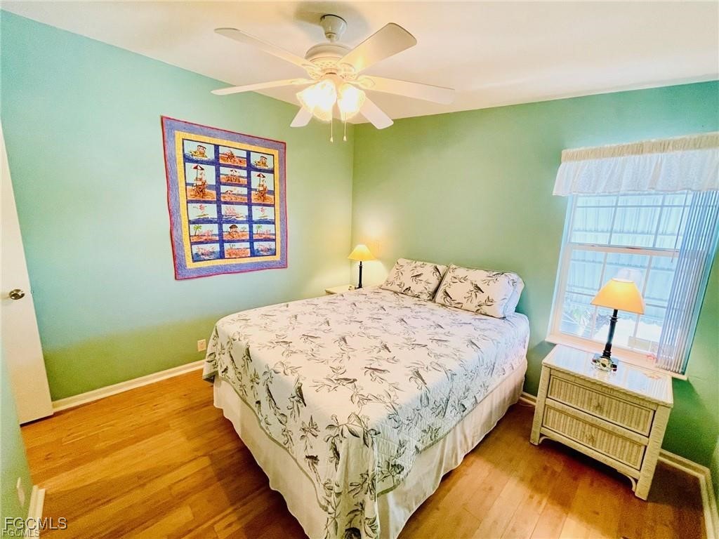 3064 Sloop Lane St. James City, FL 33956 - Photo 18 of 30 a bedroom with a bed and a chandelier